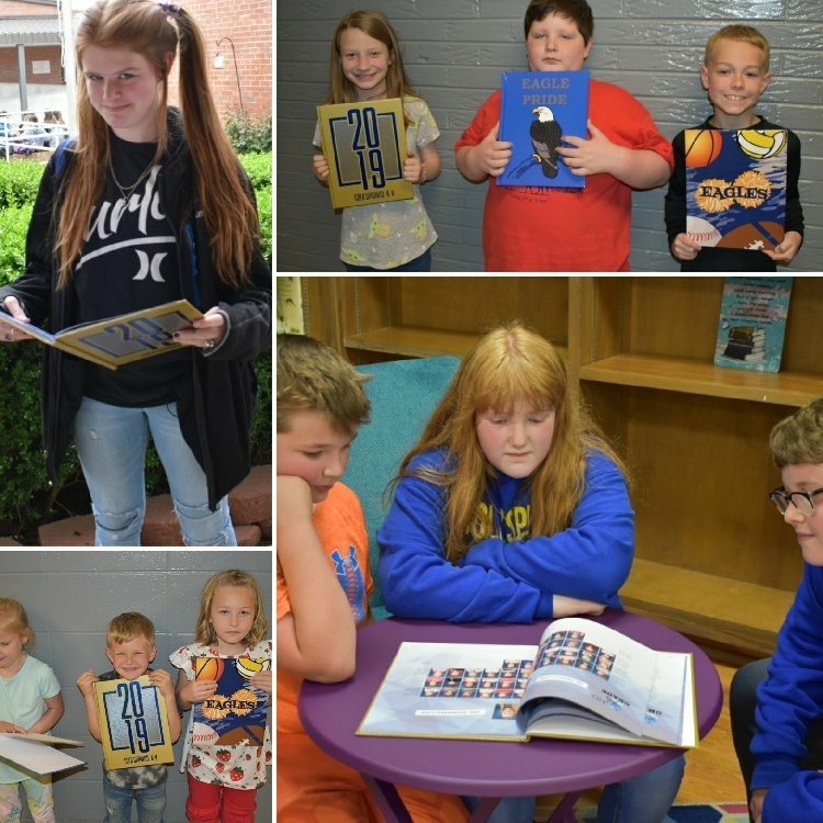 Students from kindergarten to 8th grade holding yearbooks.